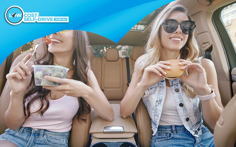 thumbnail friends snacking in the vehicle, Australian food, January 2024, Set off on Australia’s favourite road trip and discover scenic drives, local secrets, and unforgettable stops across the country's most iconic routes.